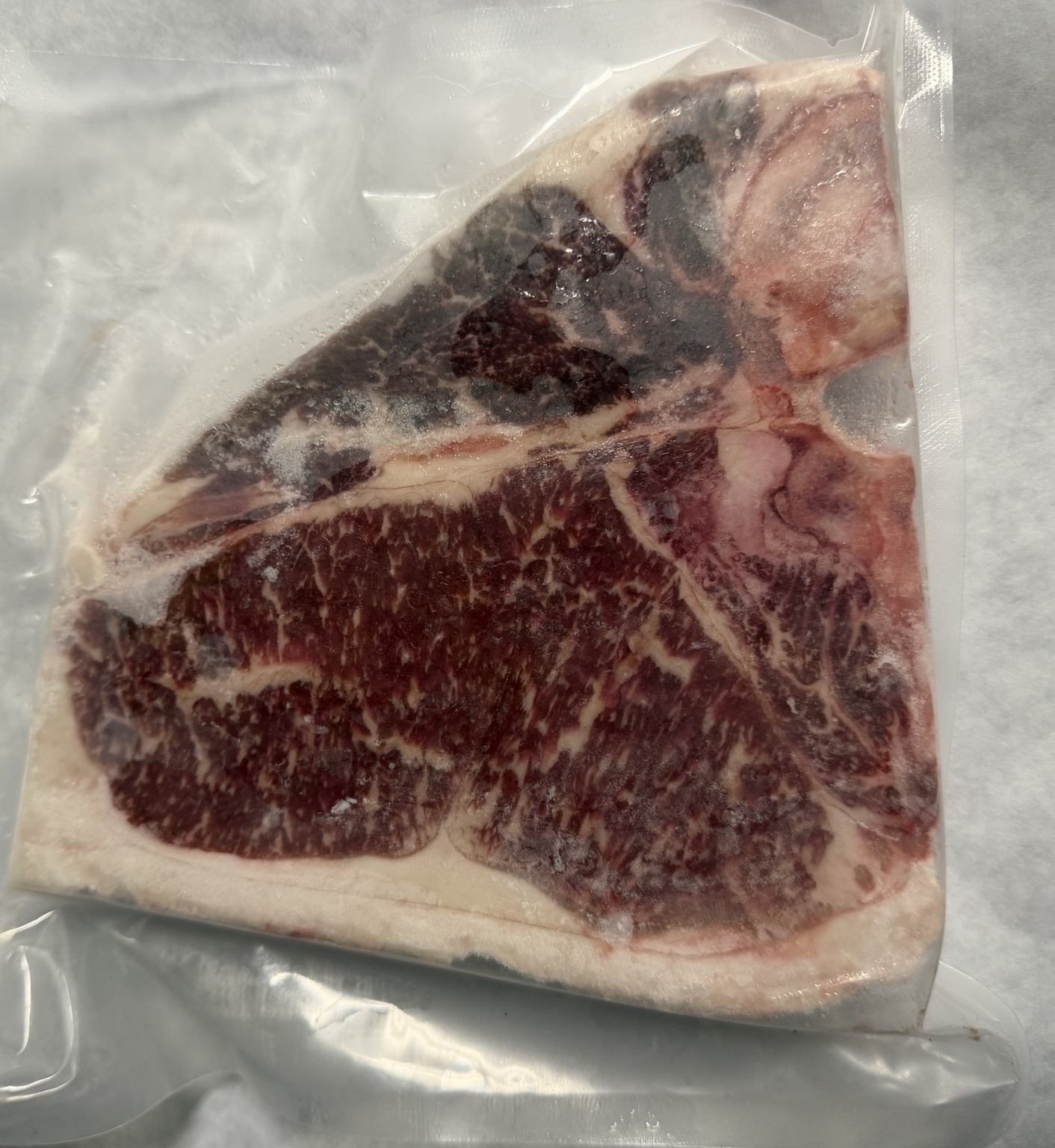 Marbled Davidson Farm American Wagyu T-bone steak in vacuum-sealed packaging